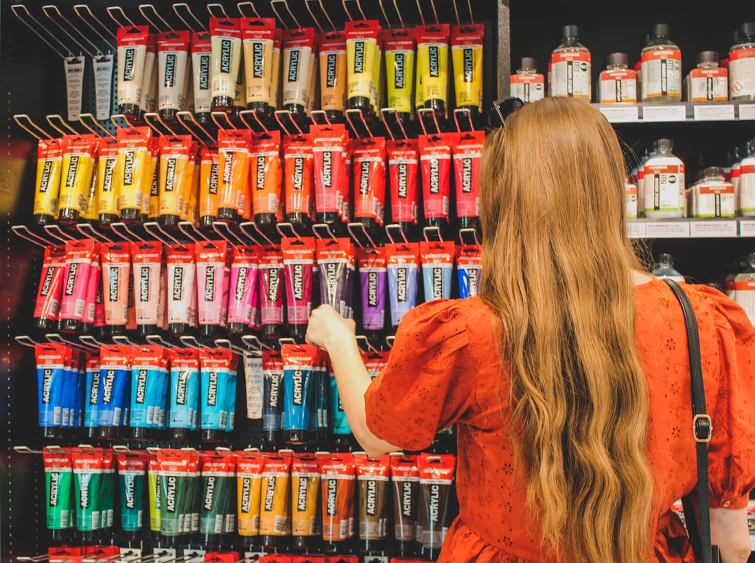 a woman in a red dress is looking at a display of hair products