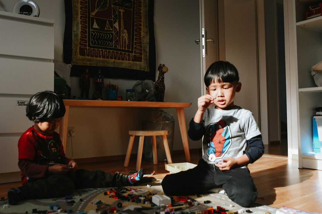 a couple of kids that are sitting on the floor