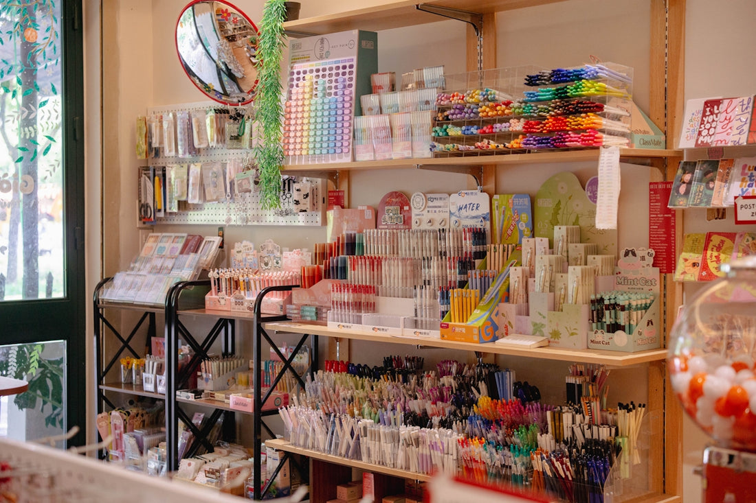 Colorful products on display in a well-stocked stationery store.
