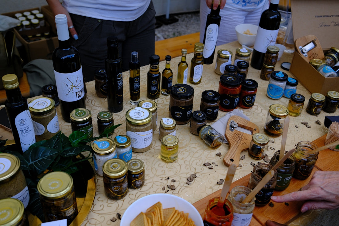 Variety of artisanal food products, oils, and wines on display.