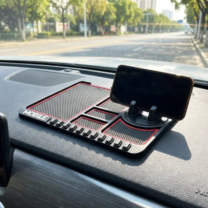 Car dashboard mat with textured gray surface, red border, phone stand and control panel area