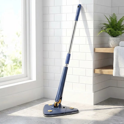 Blue extendable triangle mop with triangular grey pad in a corner on tile