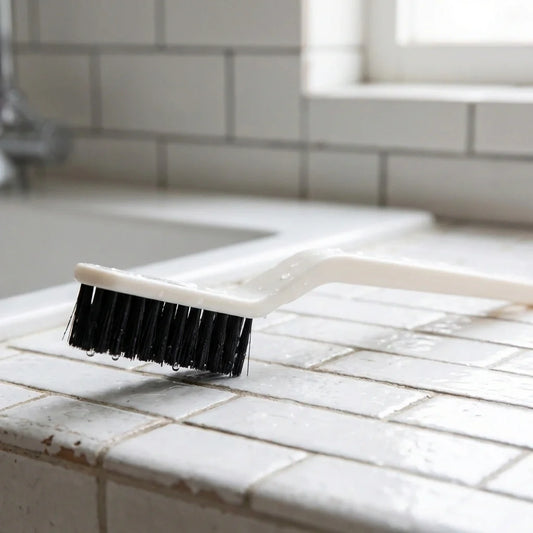 2-in-1 floor gap cleaning brush with black bristle head and white handle