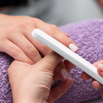 Professional nail file with white handle and grey sanding surface
