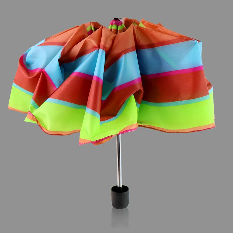 3-fold travel umbrella: folded rainbow-striped canopy in orange, blue, and green tones