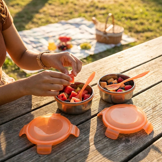 3-tier stainless steel lunch box with orange lids, open compartments for food