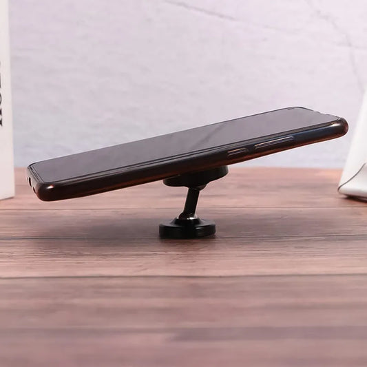 Magnetic rotating phone holder with black base and slim stand, angled view