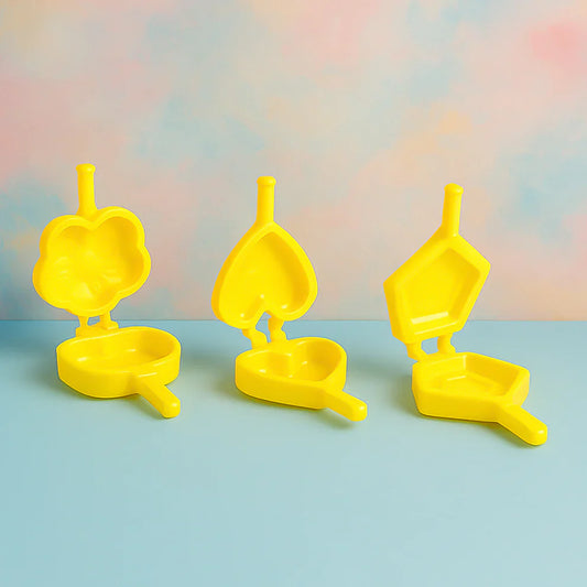 Plastic cookie cutter set with three yellow shapes on bases