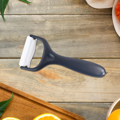 Black-and-white vegetable peeler with ergonomic handle and exposed blade