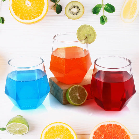 Colorful pilsner glasses set with clear rims, featuring blue, red, and orange drinks