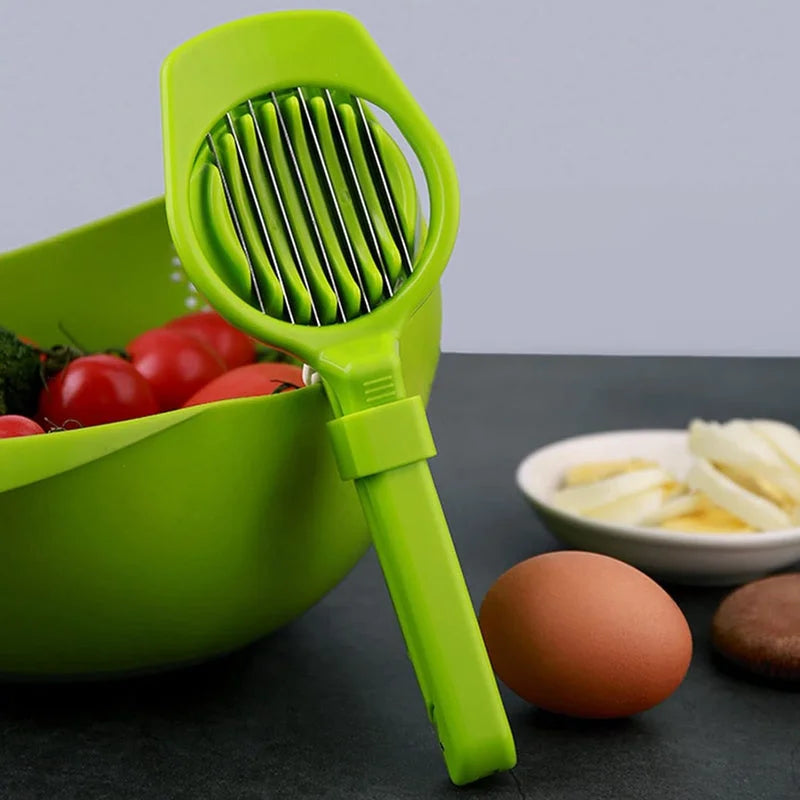 Green 7-blade handheld food slicer with rotating blade drum and handle.