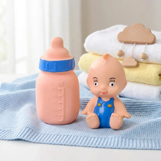 Baby bottle squeeze toy with blue cap and seated baby figure in blue overalls