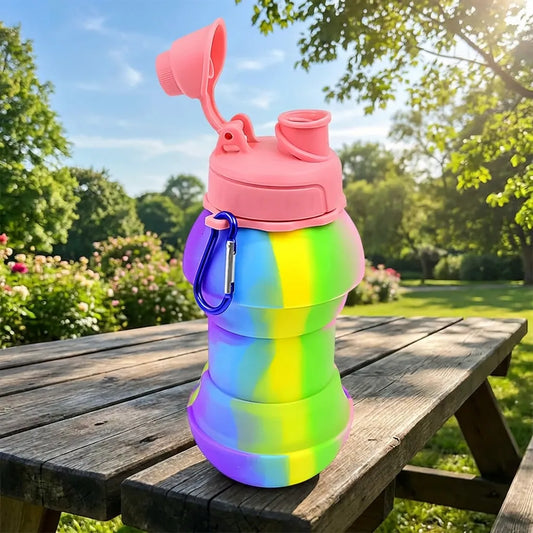 Collapsible water bottle with flip-top lid, carrying loop, and translucent gradient body