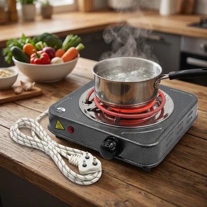 Electric countertop stove with steaming stainless pot, raised red coil ring and power cord