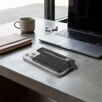 Adhesive card phone holder with zip pocket, holding a phone, dark gray