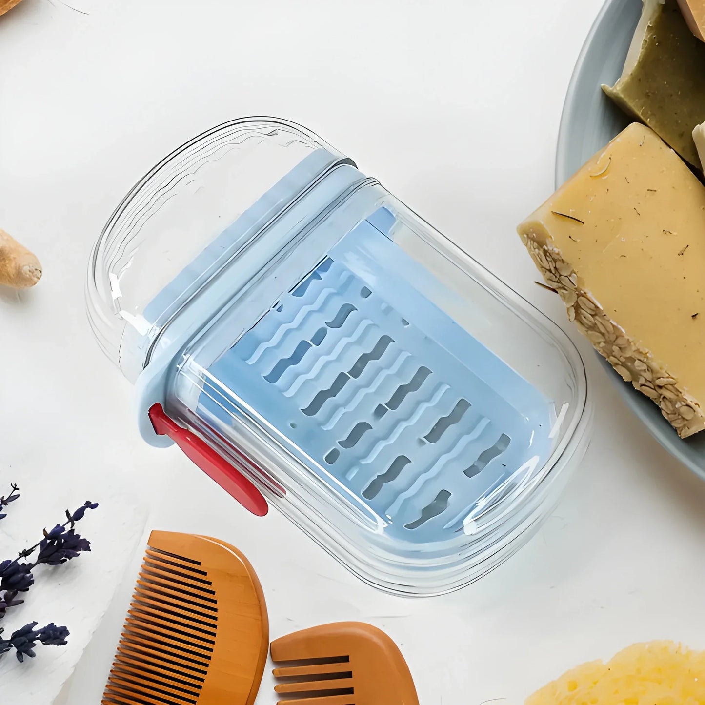 Clear plastic soap case with blue vented insert and red latch