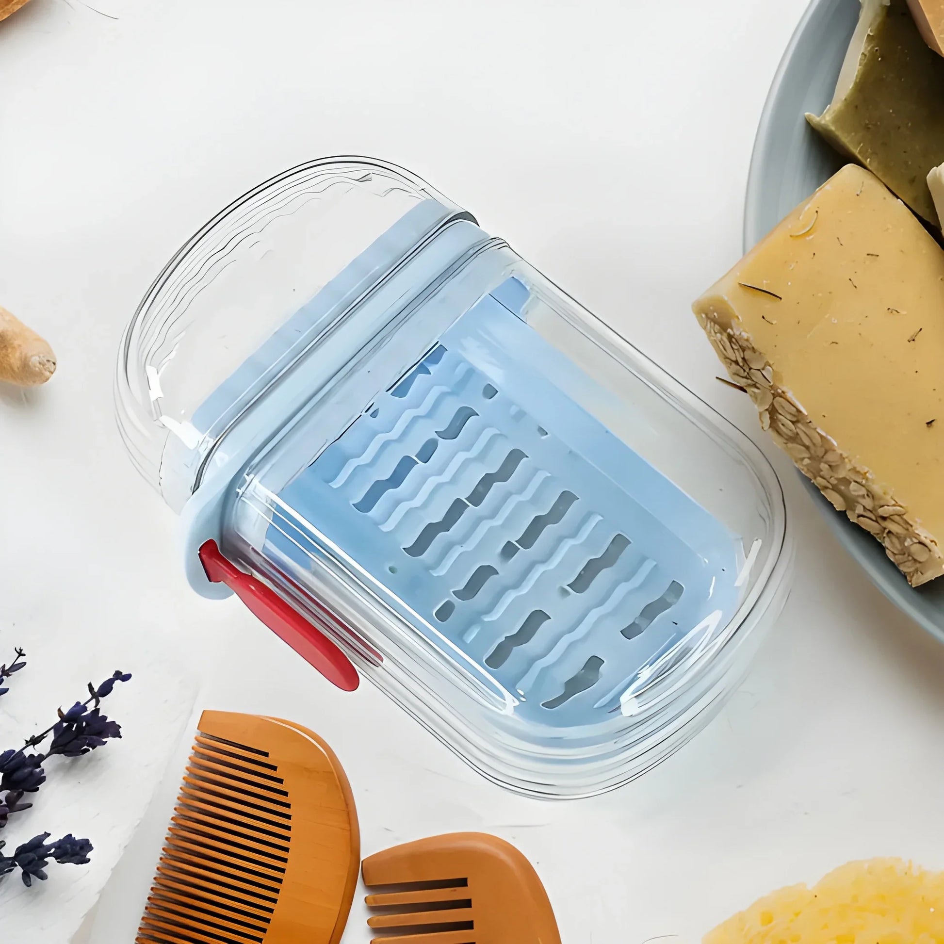 Clear plastic soap case with blue vented insert and red latch