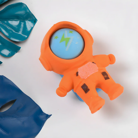 Orange astronaut-shaped eraser with blue helmet circle and star lightning design