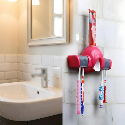 Red automatic toothpaste dispenser on bathroom wall with toothbrush holders