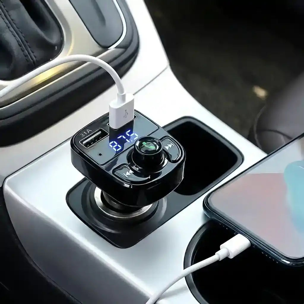Bluetooth FM transmitter close-up on console, black unit with USB ports and cable connections.