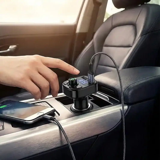 Bluetooth FM transmitter in car console, black device with display, knob, and charging cable.