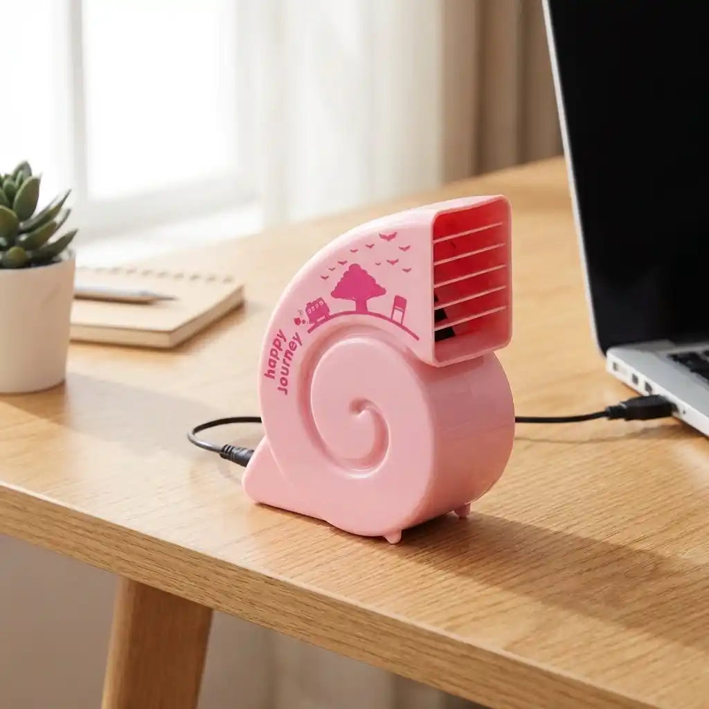 Pink USB mini fan with red grille, USB cable plugged in