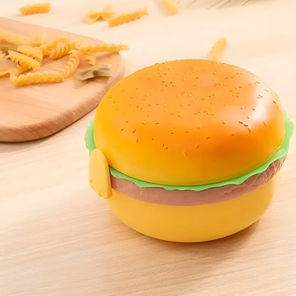 Burger-shaped kids' lunchbox with yellow bun and green lettuce, hinged lid