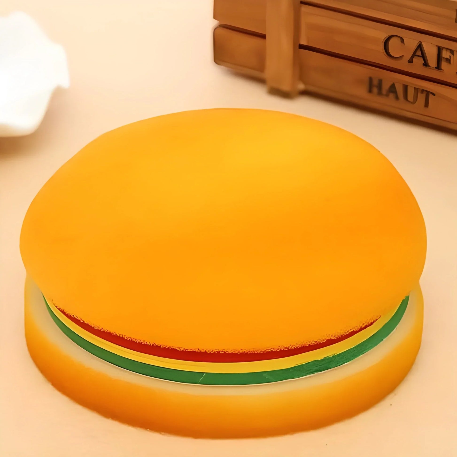 Burger-shaped notepad with yellow bun, green lettuce, and orange base.