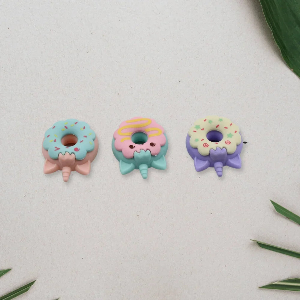 Cartoon donut eraser set of three: blue, teal, and purple donut faces