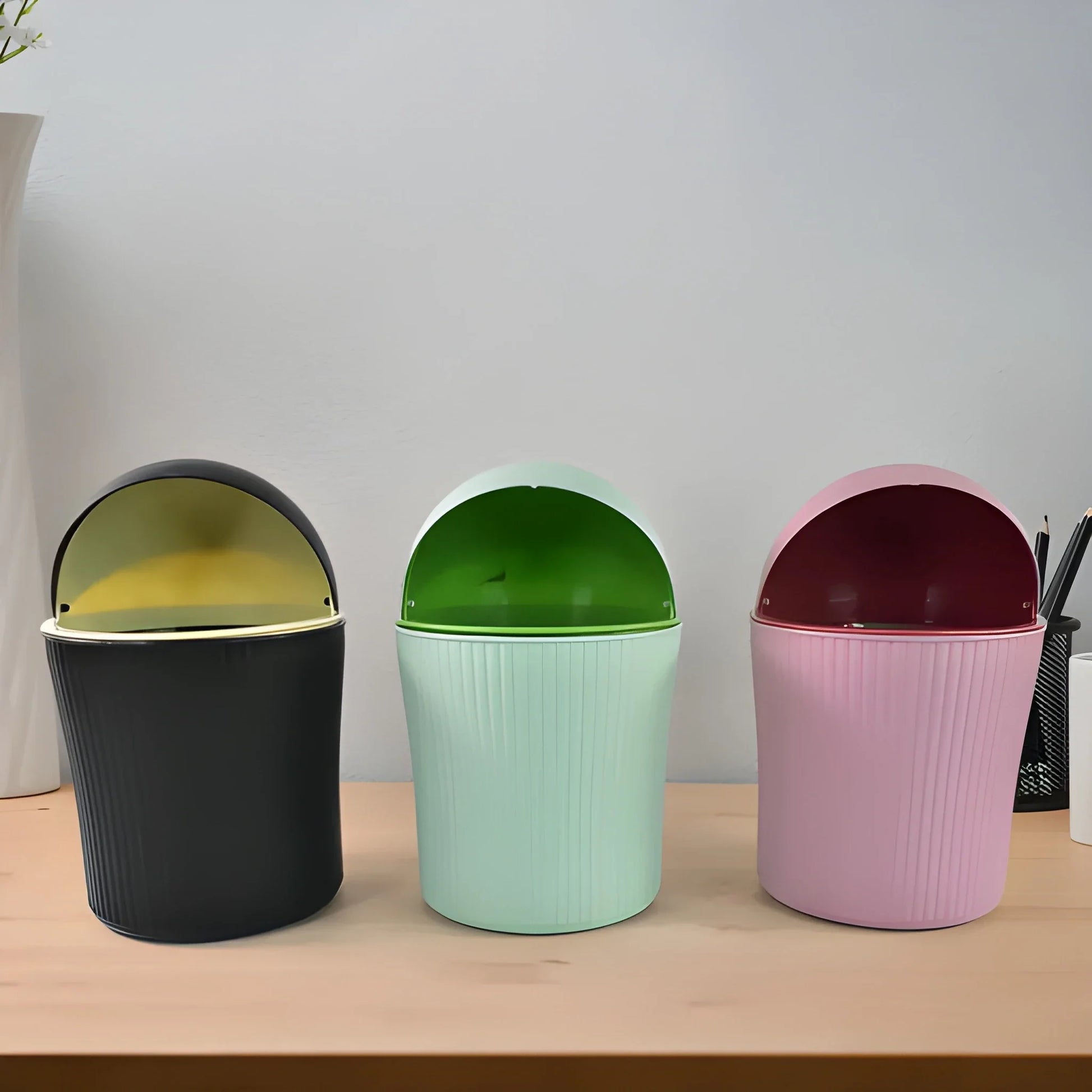 Swing-lid waste bins set: dark gray, mint green, and blush pink containers