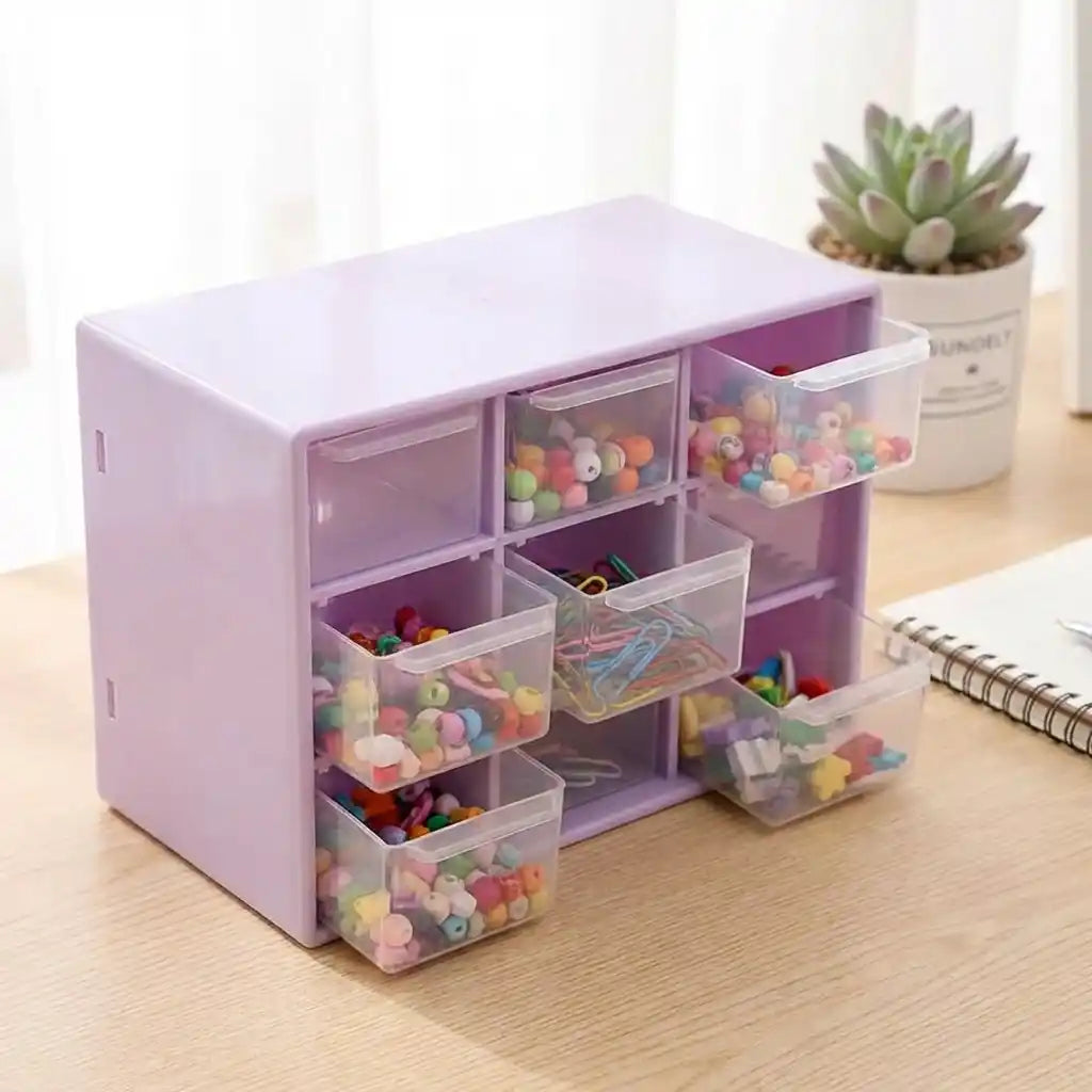 Compact jewelry drawer organizer with lid open, clear bins and small drawers, purple tinted