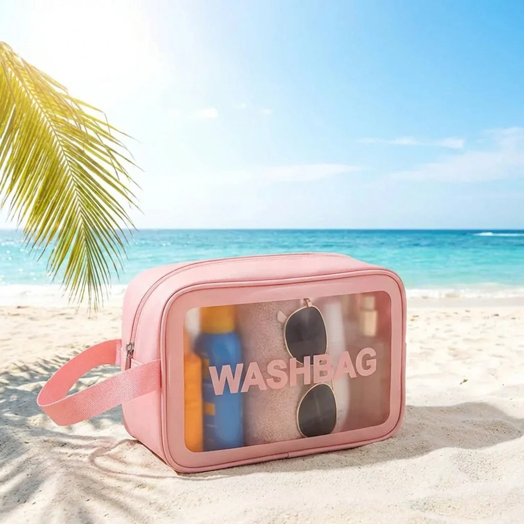 Pink cosmetic wash bag with clear front panel, zipper, wrist strap, WASHBAG logo