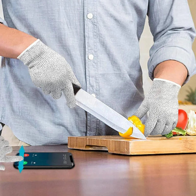 Cut-resistant safety gloves in light gray knit, held while cutting with a utility knife