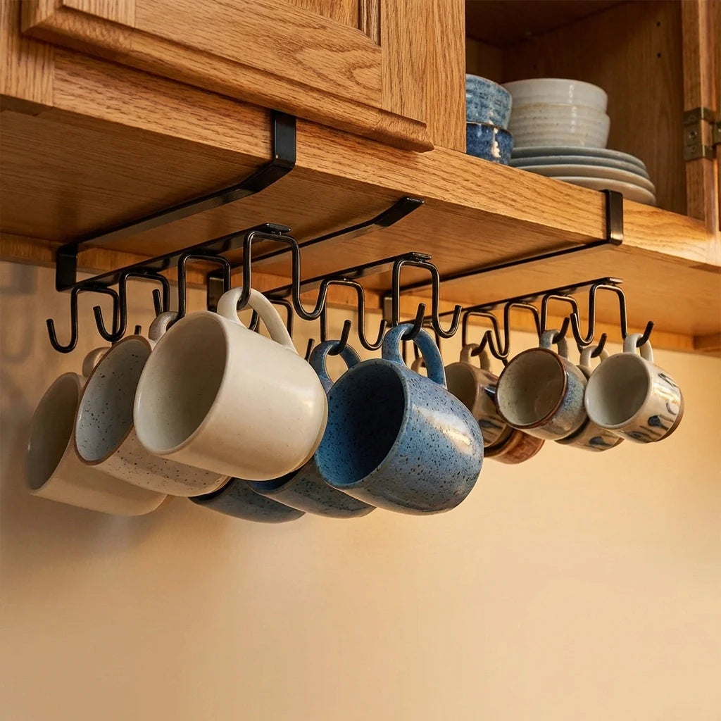 Double-row iron pot hanger with 6 black hooks tucked under wooden cabinet holding mugs