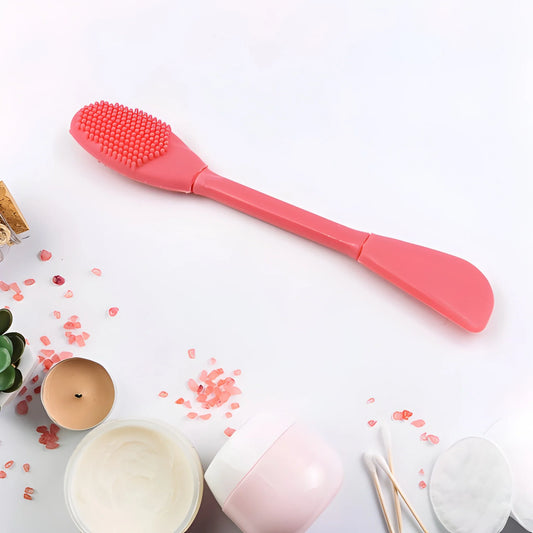 Dual-sided mask brush with textured applicator head and pink handle