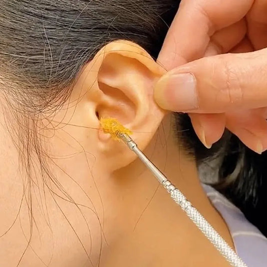 Ear wax removal tool with metal wand applying tip to ear