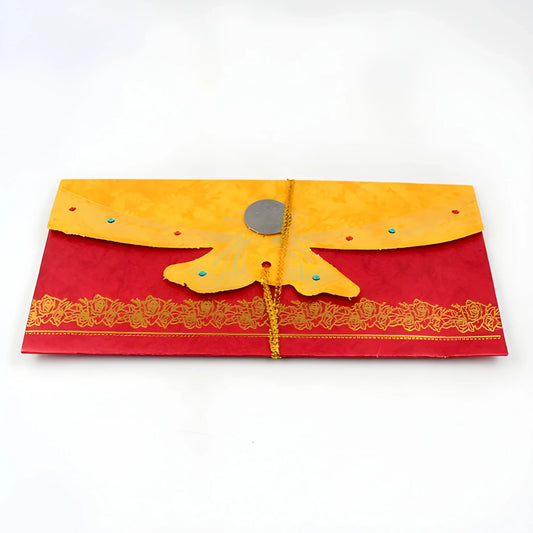 Shagun gift envelope, red with gold lace border and yellow tied flap