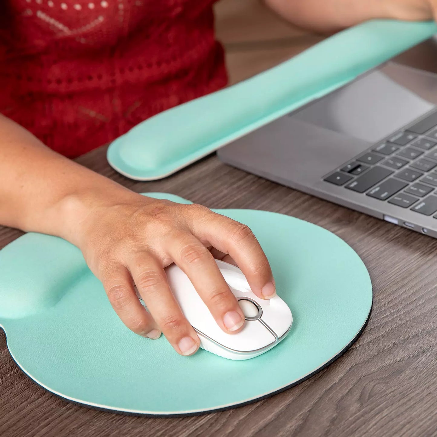 Ergonomic wrist support mouse pad with curved teal wrist rest and white mouse