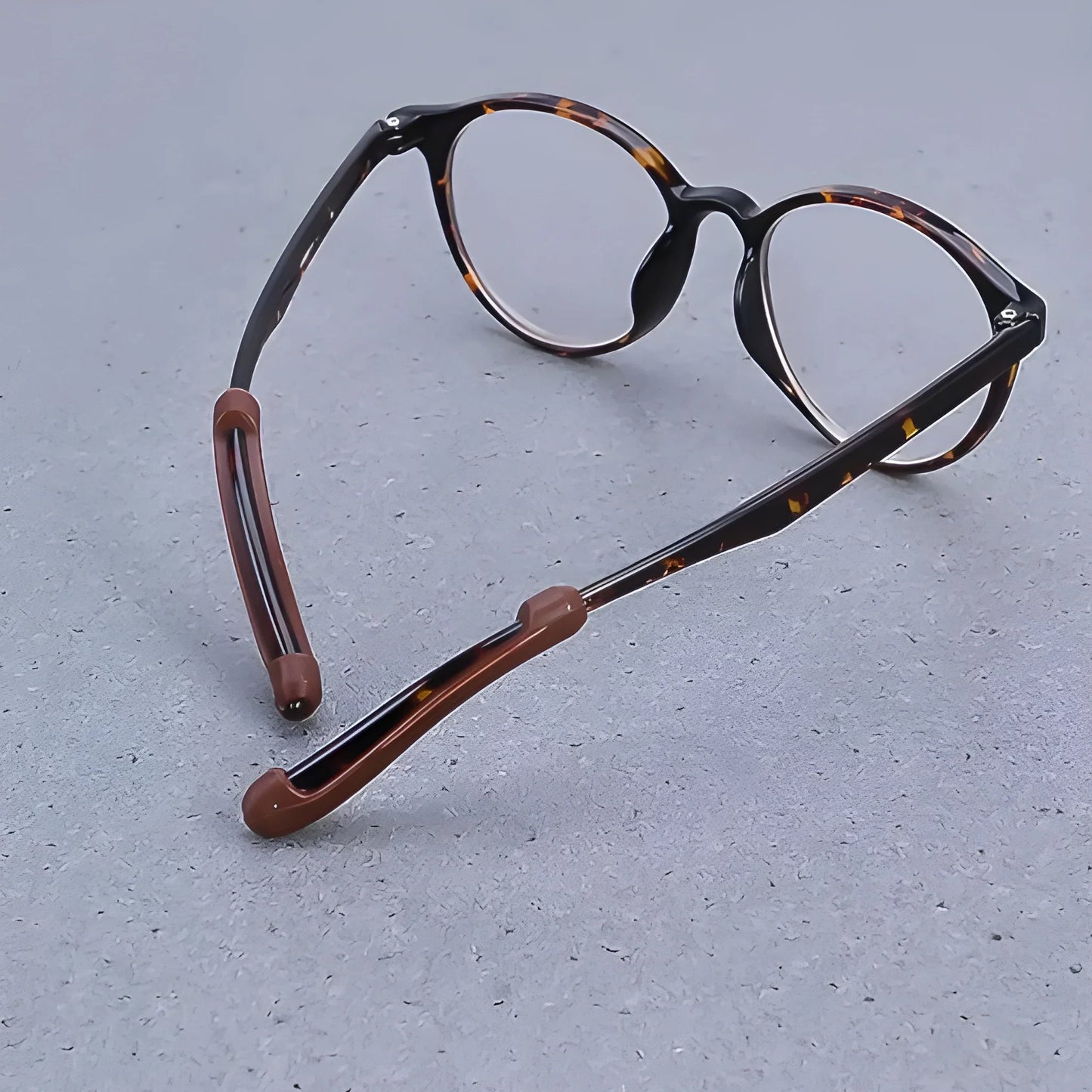 Eyeglass anti-slip ear hooks with brown silicone tips on curved arms