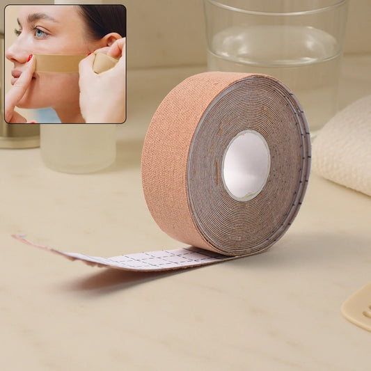 Face lifting and tightening tape roll with adhesive backing strip, beige fabric