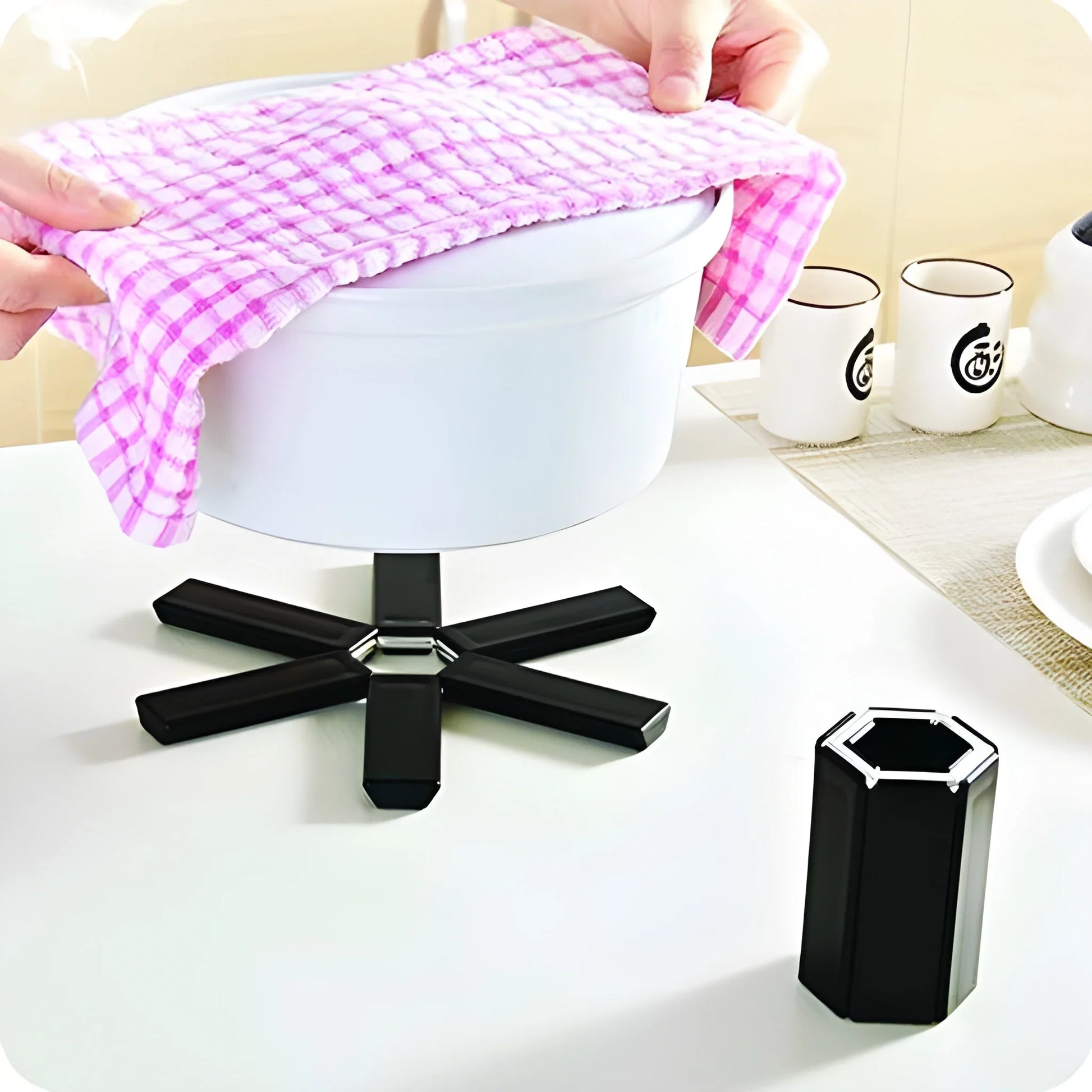 Foldable silicone hot mat, purple checkered fabric sheet folded on display