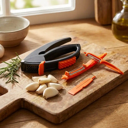 Garlic crushing tool with orange accents and black handles on wooden cutting board