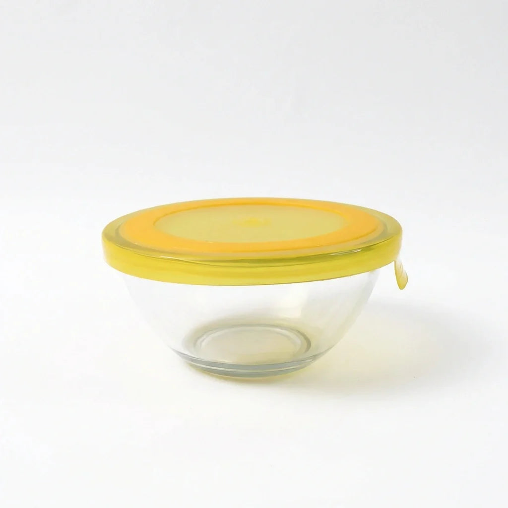 Glass mixing bowl with yellow lid, no contents