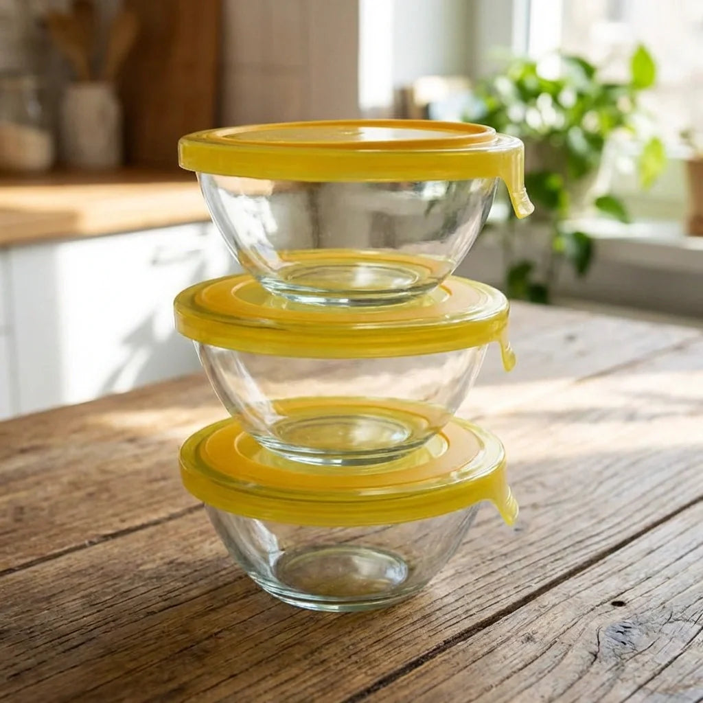 Glass mixing bowl set with yellow lids, three stackable bowls, clear glass