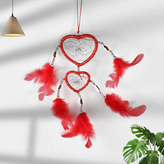Red heart dreamcatcher wall hanging with white web and red hanging feathers