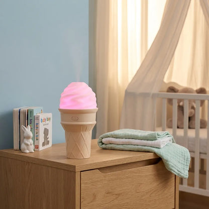 Ice cream-shaped LED humidifier with pink swirled light top on wooden cabinet