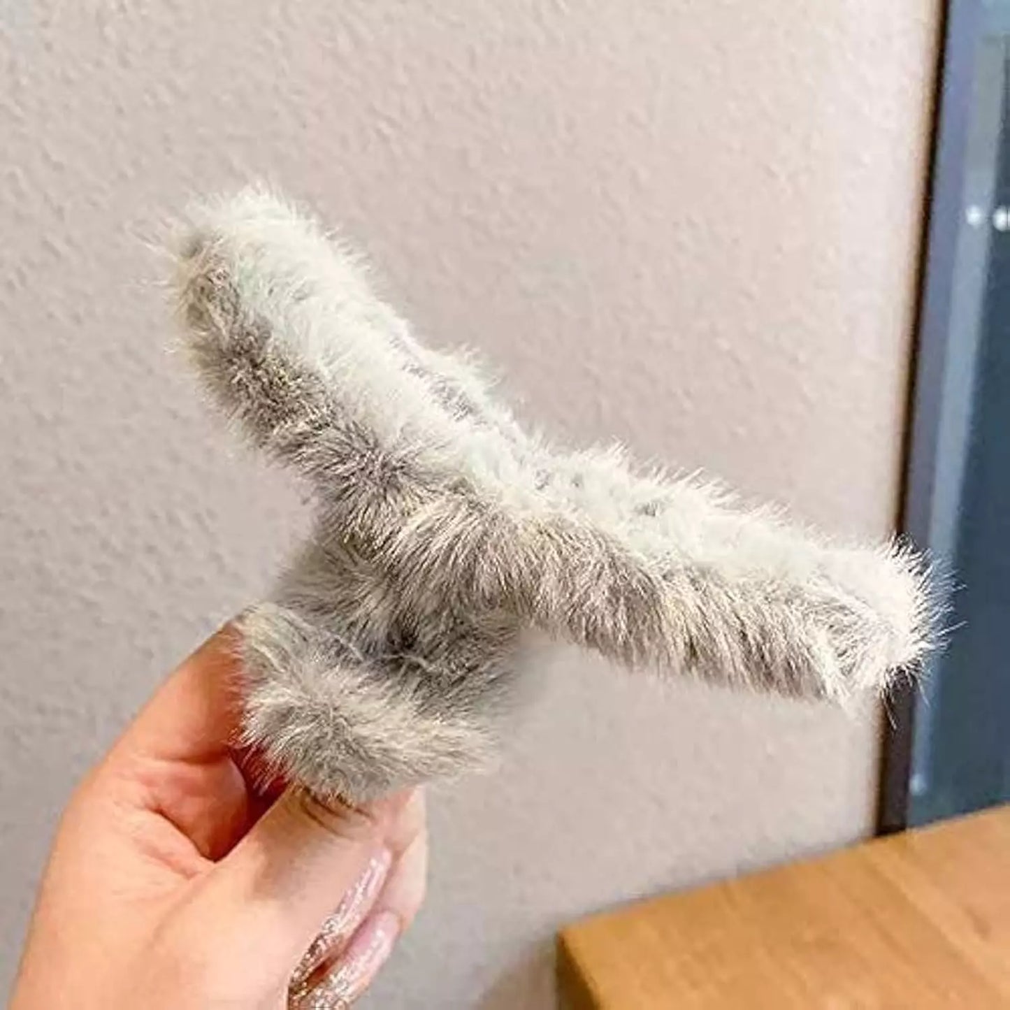 Large plush hair claw clip, fuzzy light gray, curved claw shape