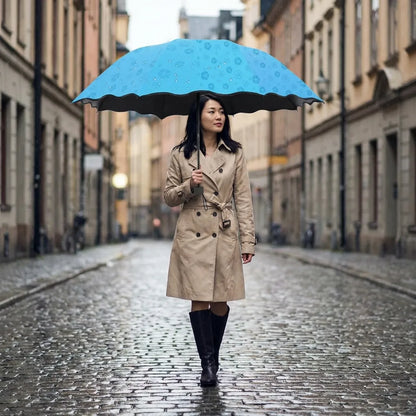 Blue flower-pattern umbrella with black scalloped edge, held open above person