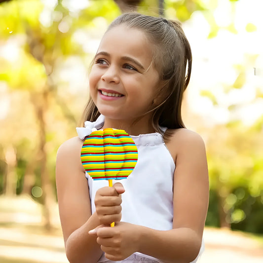 Flower spinning toy with rainbow-striped petals held by a child