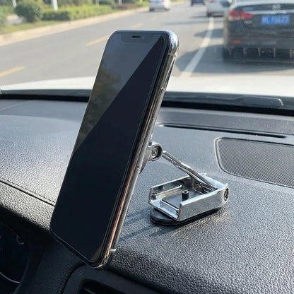Magnetic car phone holder with dark phone angled on dashboard